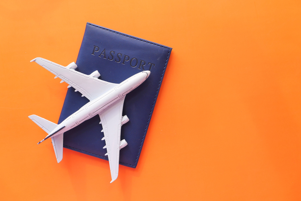 Travel Vacation Concept with Plane and Passport on Color Background